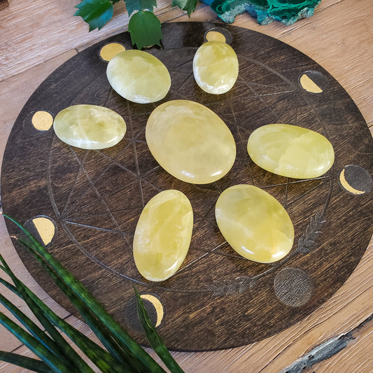 Lemon calcite palmstone, cheerful yellow glowing crystal