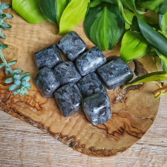Large tumbled larvikite stone, dark crystal with blue-grey schiller