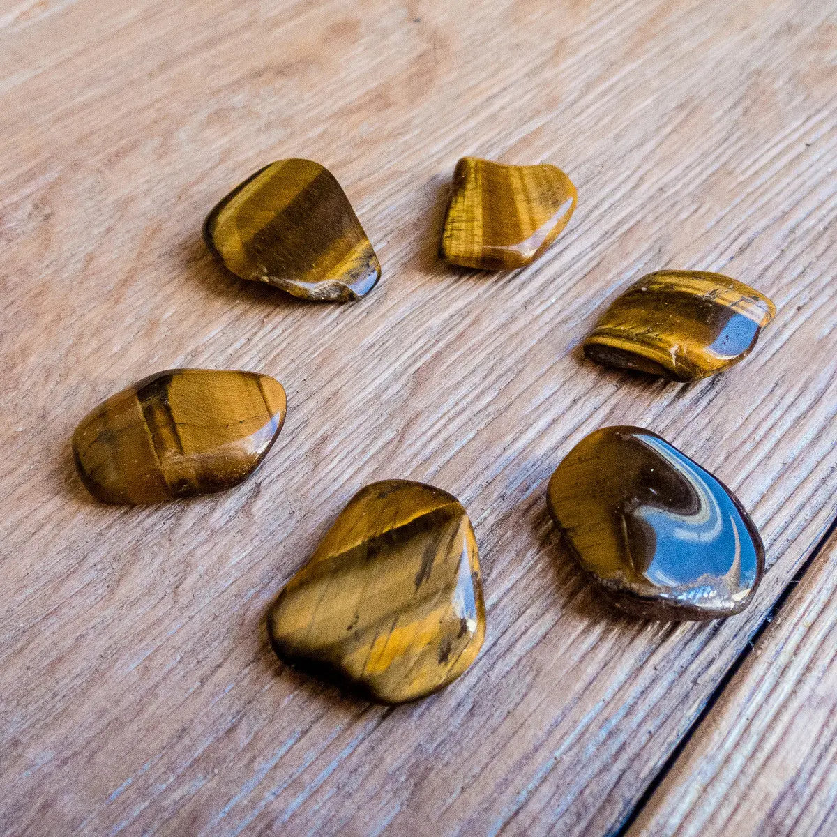 Tumbled tiger eye stones showing size range