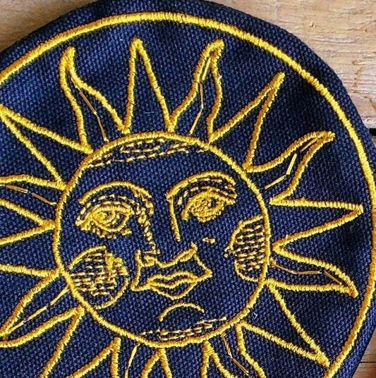 The Sun Crystal Grid Pouch from Cave & Canyon, indigo canvas with goldenrod sun embroidery